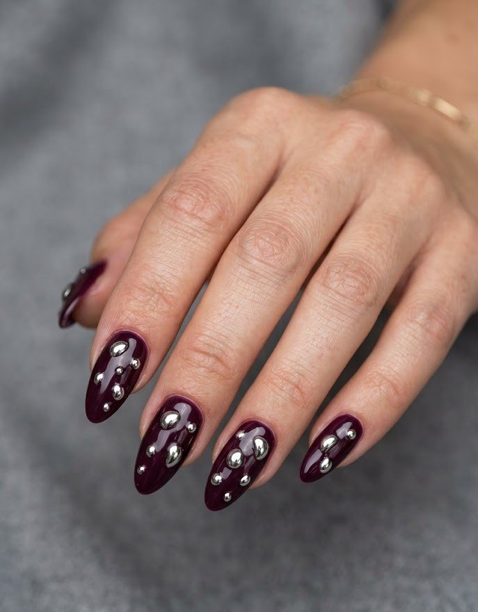 3D chrome droplets on dark plum almond nails