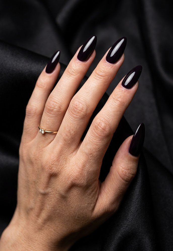 Long structured almond nails in glossy blackened plum
