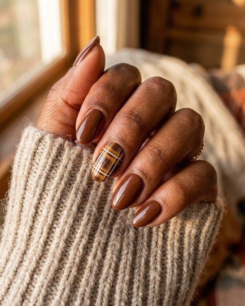 Short almond nails in chestnut brown with one brown and mustard tartan statement finger