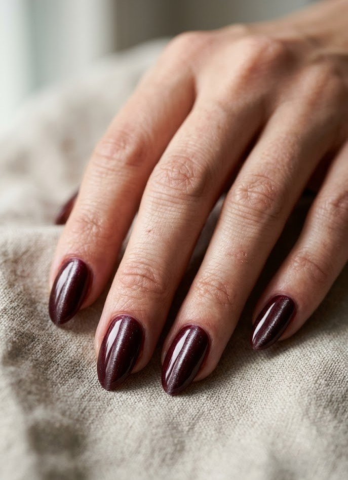 Classic vertical burgundy cat eye nails on almond shape