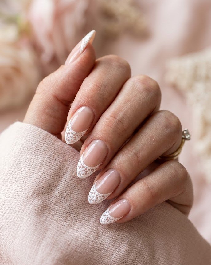 Butter yellow nails with white doily stamped pattern