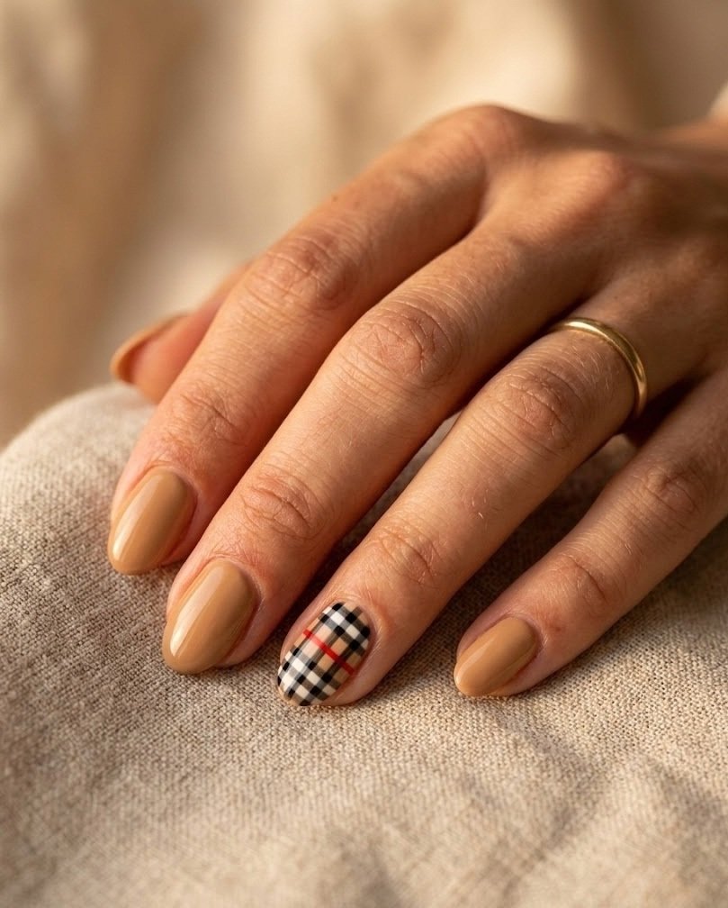 Short almond nails with a camel Burberry style check accent and one red line