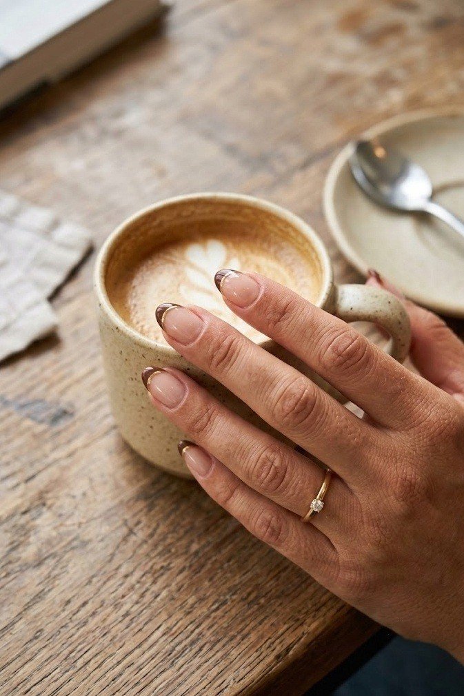 Cocoa brown micro tip with skinny gold underline on short almond nails
