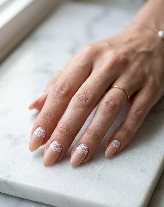 Doily half-moon nail art at the cuticle on nude nails