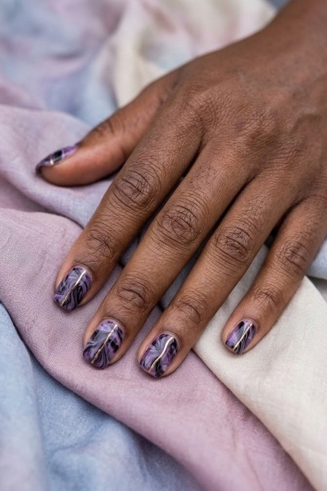 Short milky white nails with fine black cobwebs on two accent nails