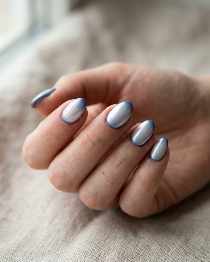 Cool navy short almond nails with a soft pearl chrome glaze on beige linen
