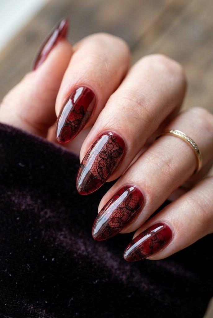Oxblood jelly nails with black lace suspended inside a glossy coat