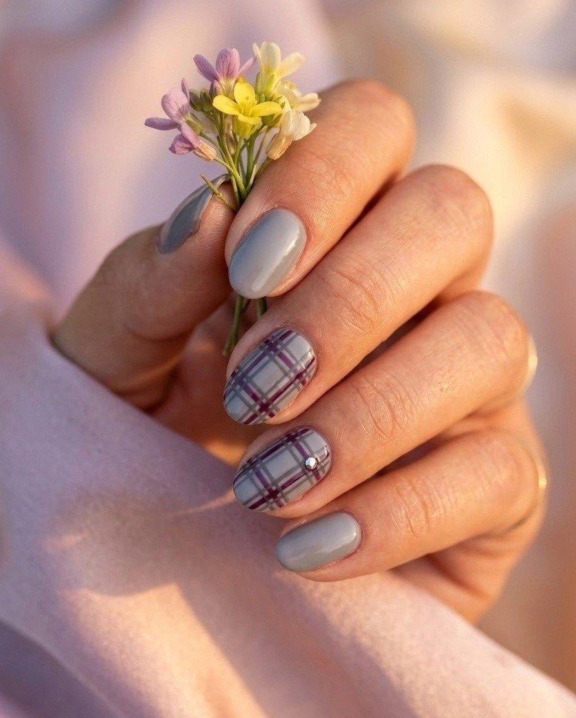 Short almond nails with plum and gray plaid and a tiny silver stud accent
