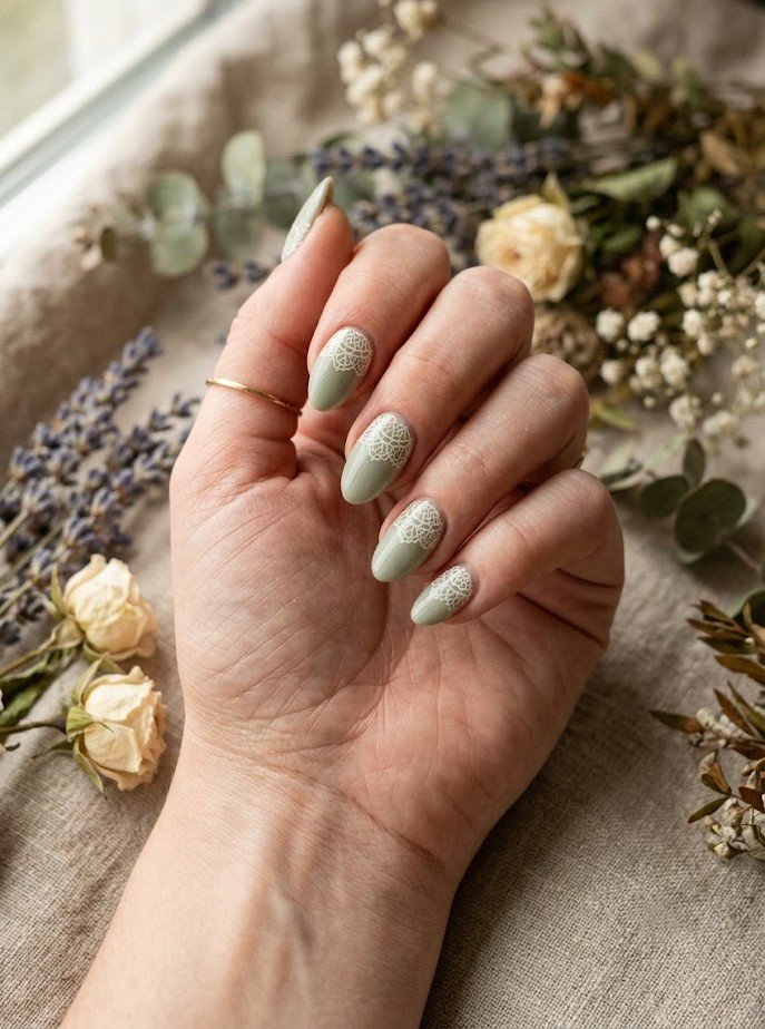 Sage green cottagecore nails with ivory doily pattern