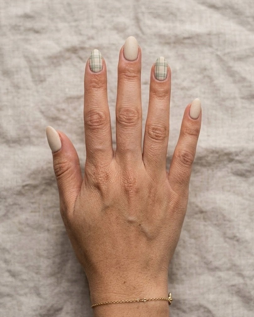 Short almond nails with low contrast sage and cream plaid on an oatmeal base