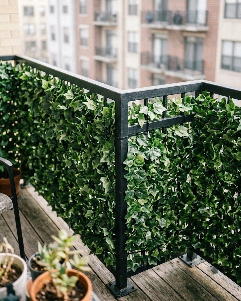 Interlocking faux ivy hedge panels covering a balcony railing section